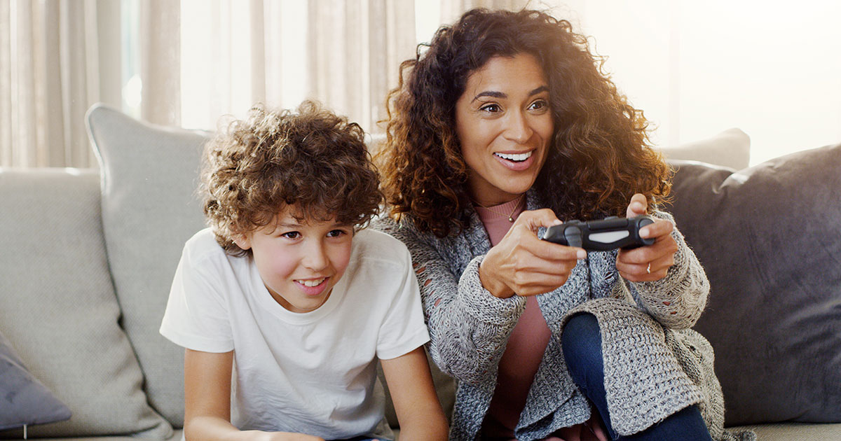 A mother plays a multiplayer video game with her son