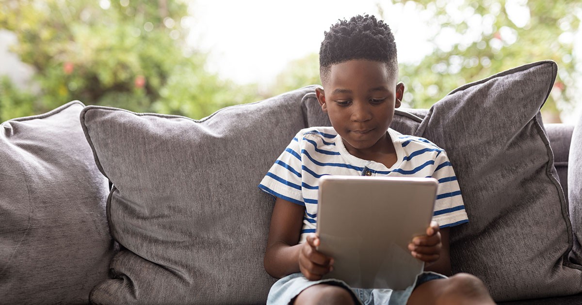 boy on couch with tablet