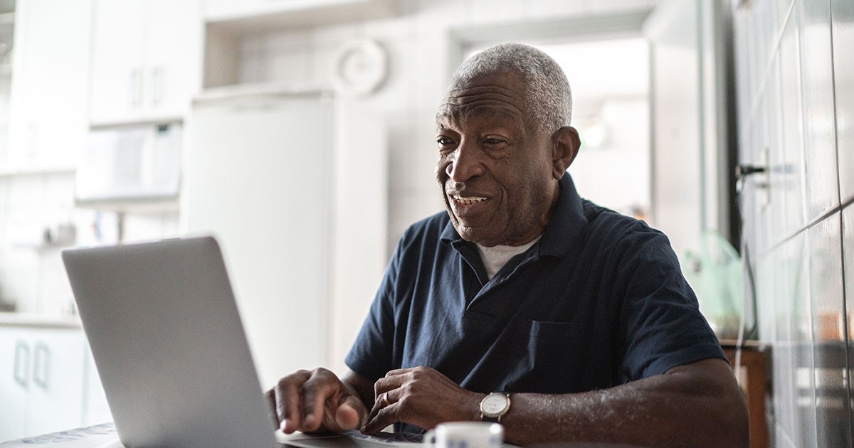 senior man uses a laptop