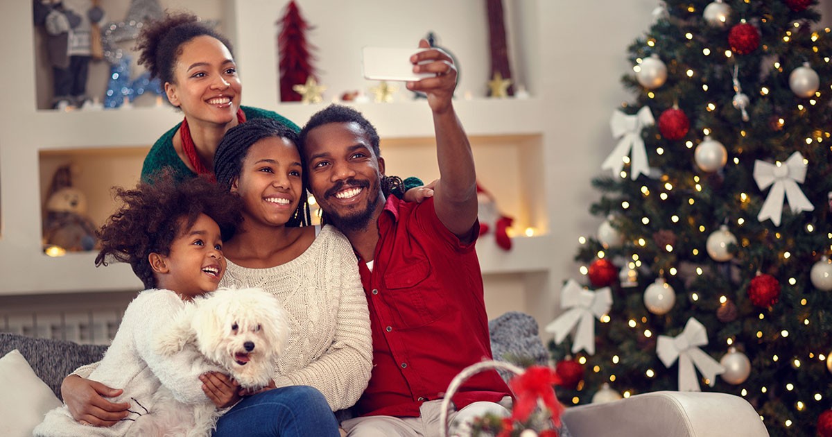 Family takes a selfie by the Christmas tree