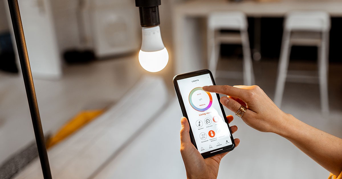 Woman uses an app to control her smart lightbulb