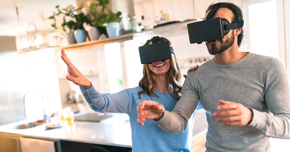 A man and woman play a virtual reality exercise video game to get more fit