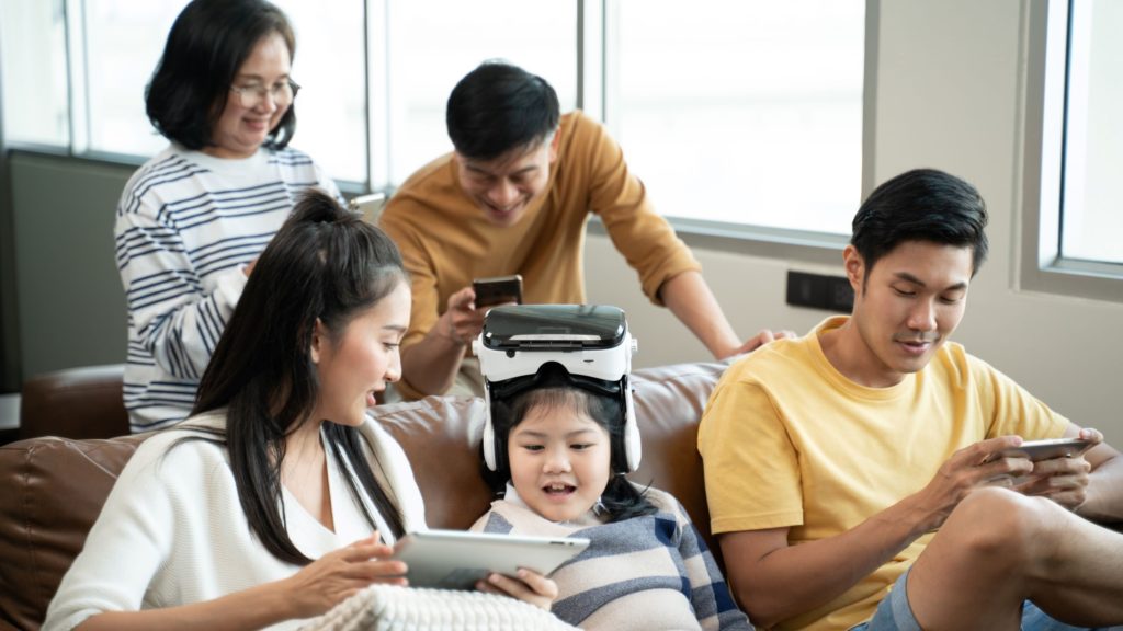 An entire family enjoys time together on their connected devices. 