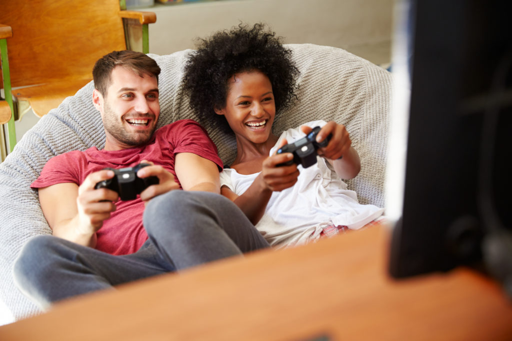 Young couple playing online games through fast CenturyLink internet connection