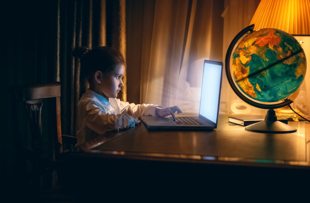 Little girl using computer with parental controls