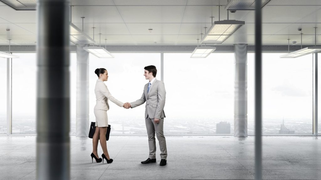 Business people shaking hands on a new real estate deal