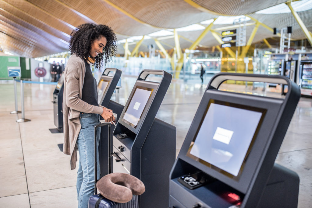 Woman using self-service kiosk at the airport