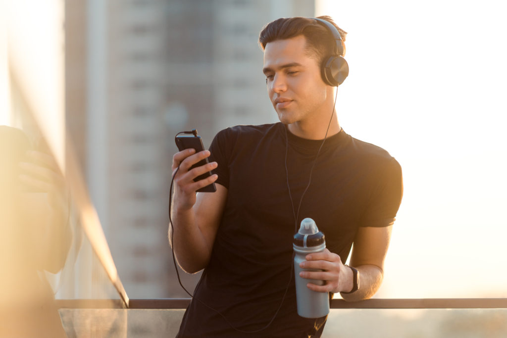 Man using noise canceling headphones during workout