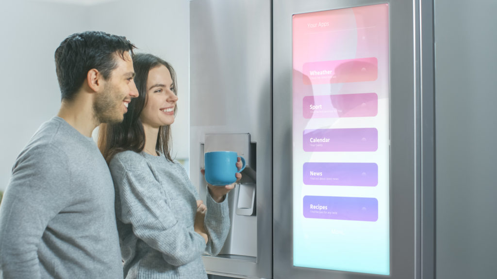 Couple using their smart fridge