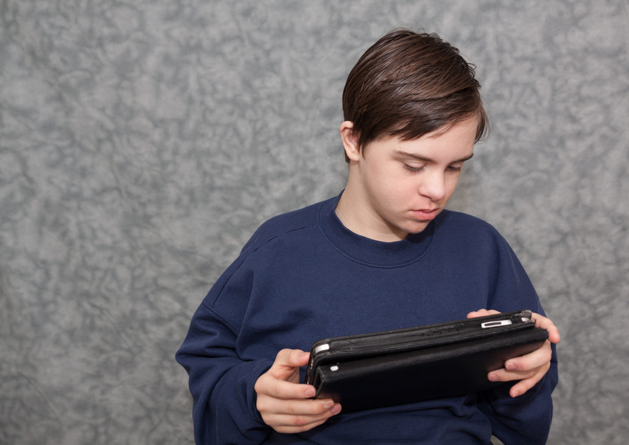 Young boy using assistive technology
