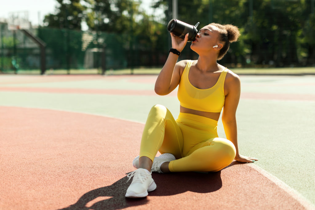 Woman staying hydrated with a smart water bottle