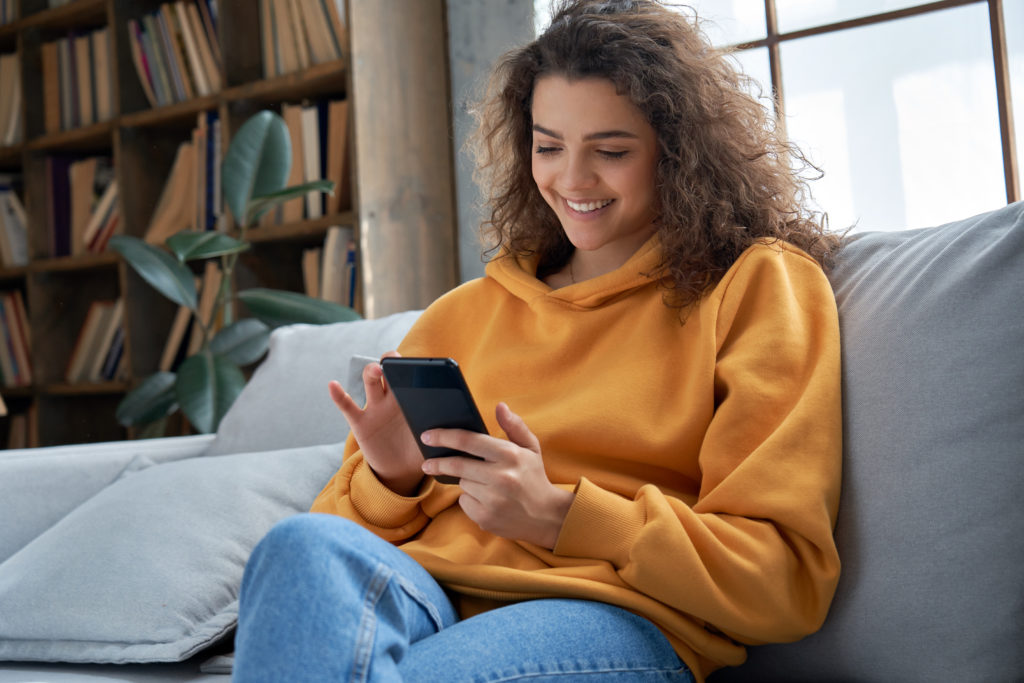 Woman in yellow sweater links her apps together to save time