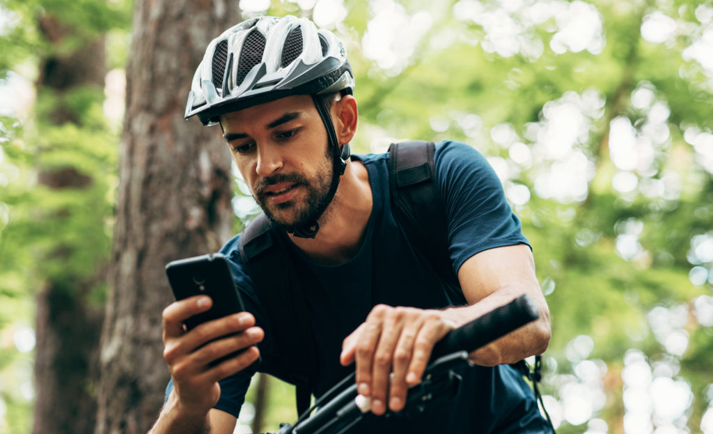 Man on a bike trail using location tracking technology