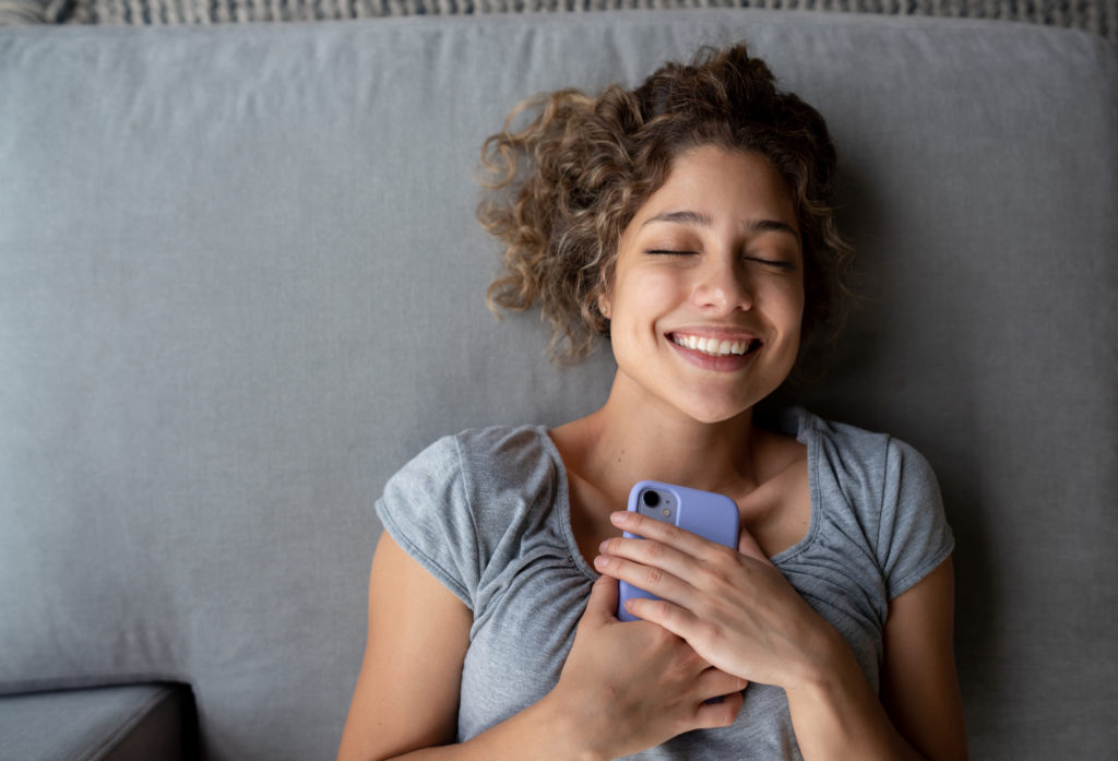Woman smiling while staying safe on a dating app